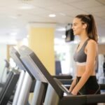 Woman enjoying a workout on a treadmill indoors, promoting fitness and health.